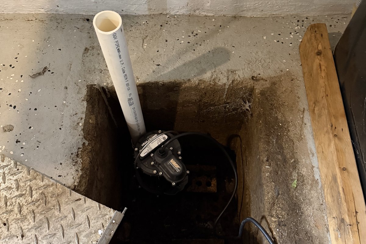Sump pump installation in a Kalamazoo basement by Alliance Plumbing